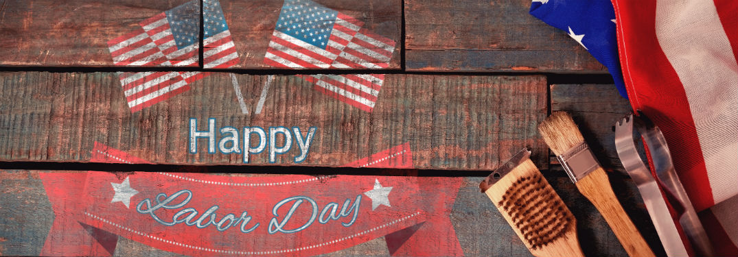 Happy Labor Day, text on an image of grilling utensils on a wooden table