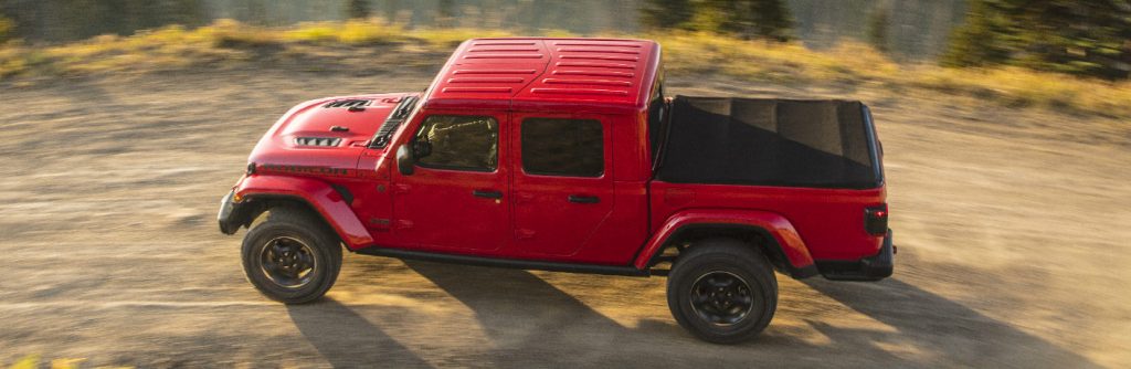 Overhead view of red 2020 Jeep Gladiator driving on a dirt road