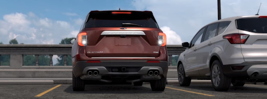 Maroon Ford Explorer backing out of a parking spot