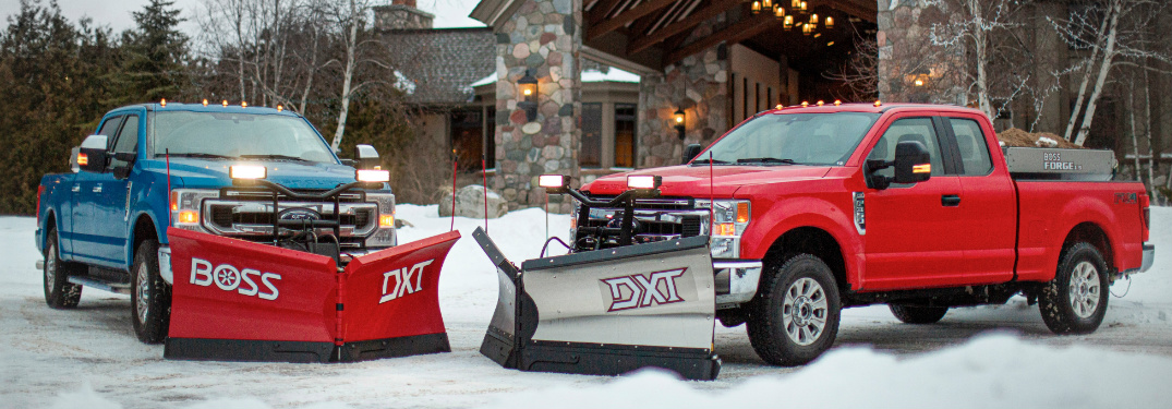 Two 2020 Ford F-Series Super Duty trucks with the Snow Plow Prep Package parked in a snowy parking lot