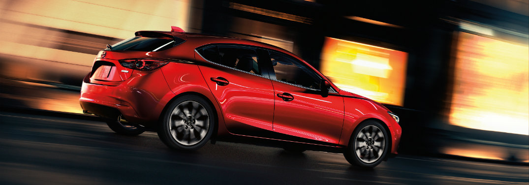 red mazda3 driving fast