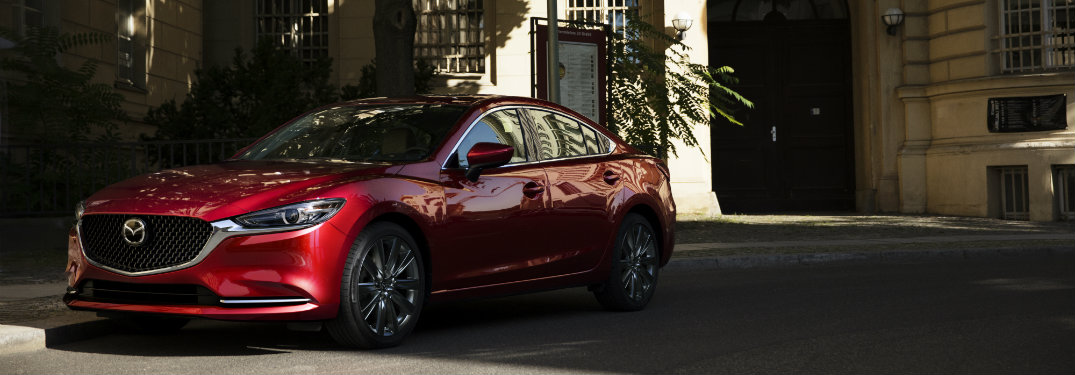red mazda6 driving in shadows