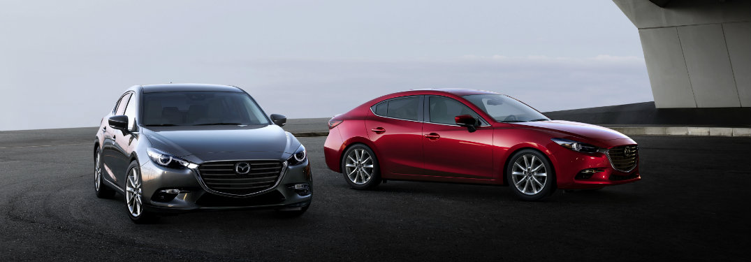 silver and red madzda3 cars next to each other