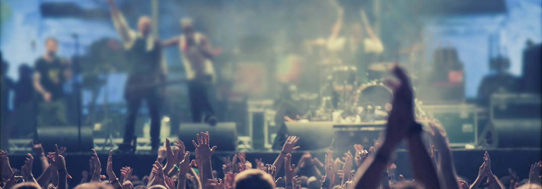 crowd cheering on band on stage