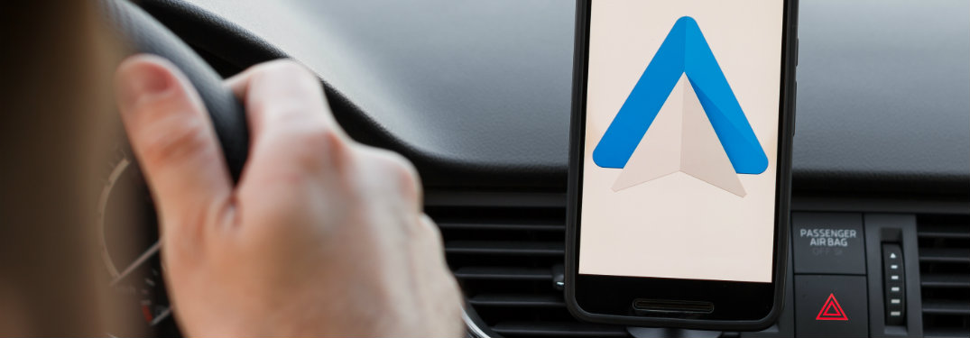 hand on steering wheel, closeup of phone