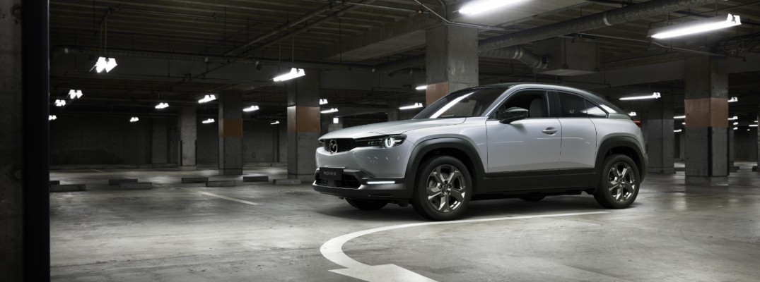 Mazda MX-30 electric vehicle EV debut at 2019 Tokyo Motor Show showcase shot with silver gray paint color parked in an underground parking garage