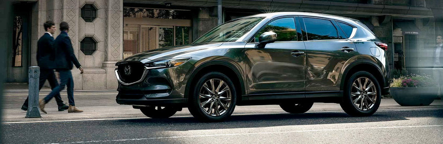 A gray 2019 Mazda CX-5 parked in an urban area.