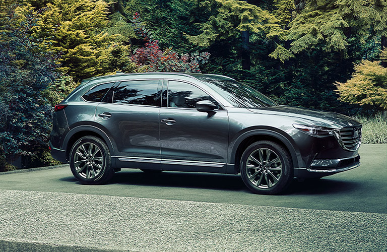 A gray 2020 Mazda CX-9 parked in a wooded area.