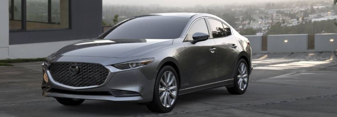 A gray 2020 Mazda3 Sedan parked in a parking lot.