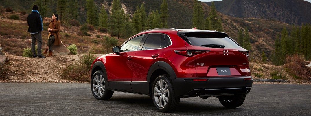 2020 Mazda CX-30 in a park with a man and a woman in the foreground