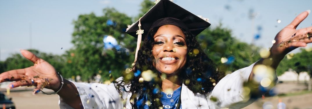 Graduate throwing confetti