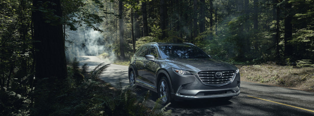 Grey 2021 Mazda CX-9 driving in forest