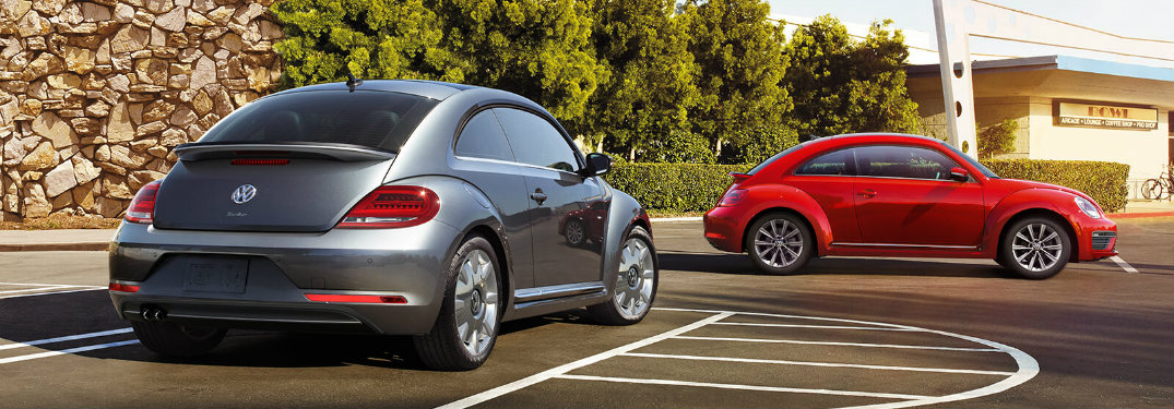 Red and gray 2018 Volkswagen Beetle models parked in parking lot