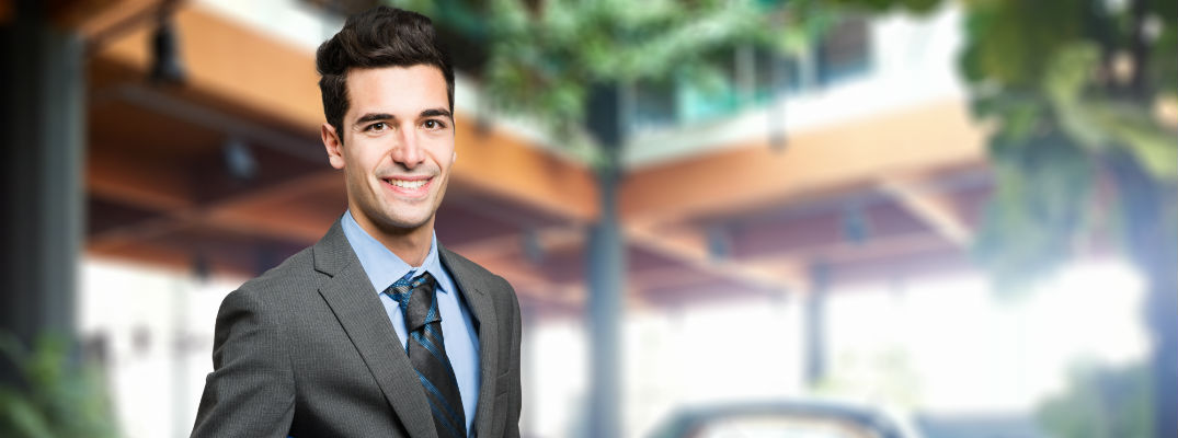 A stock photo of an automotive product expert ready to answer questions.
