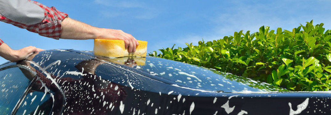 arm waxing car with a sponge
