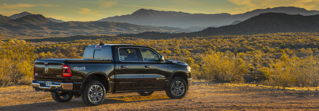 2019 RAM 1500 by field and mountains