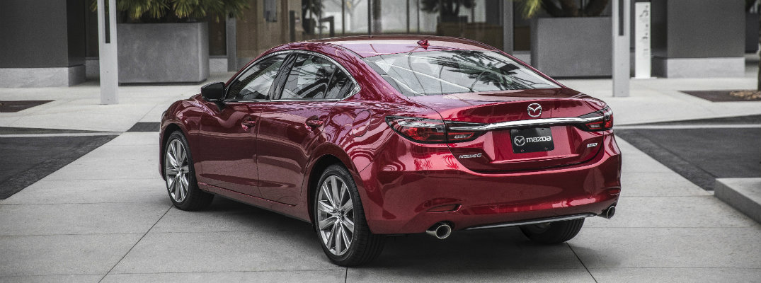 2018 Mazda6 full-size sedan exterior soul red back of trunk and bumper parked outside a luxury hotel