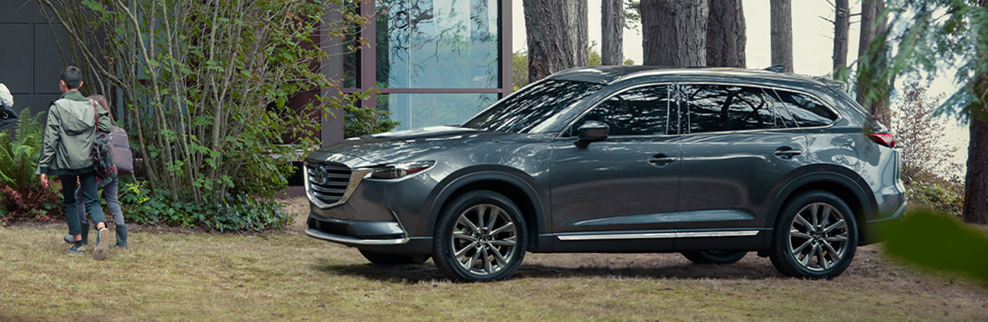 A gray 2020 Mazda CX-9 parked in a wooded area.