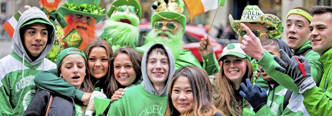 A group of people celebrating St. Patrick's Day in March at an event outside.